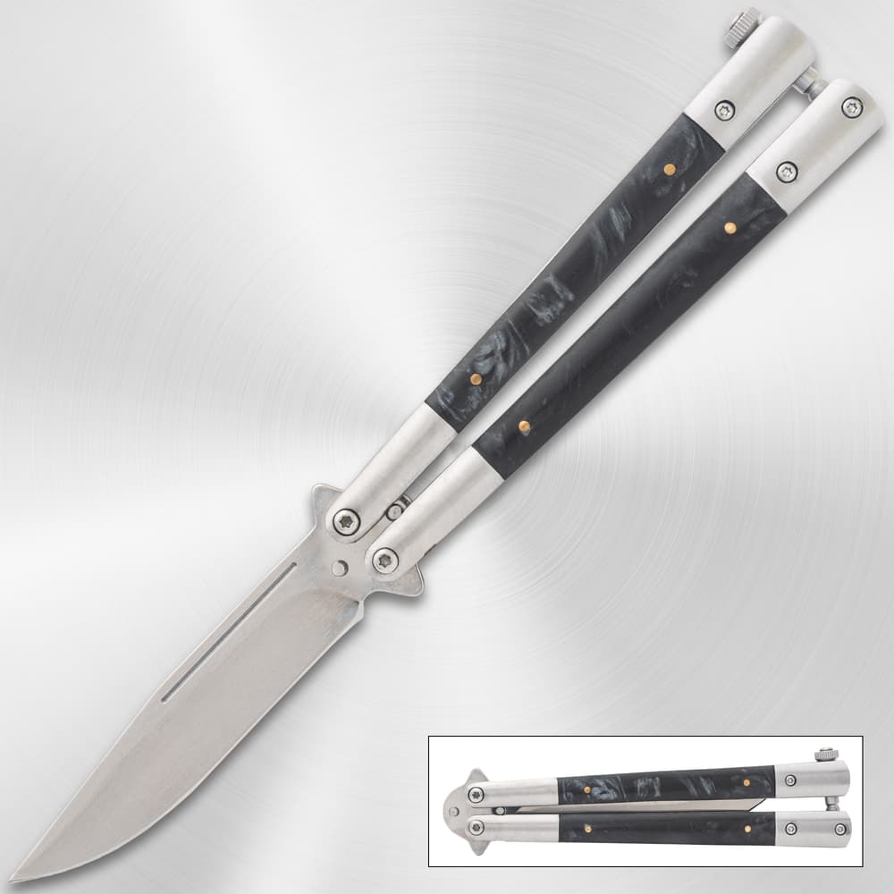 Butterfly knife with black marble handle on metallic background image number 0