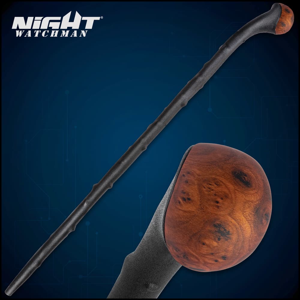 Night Watchman Blackthorn shillelagh walking stick lays across some logs on dirt ground. image number 0