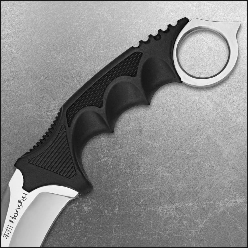 The karambit is housed in a genuine leather boot sheath with clip. image number 1