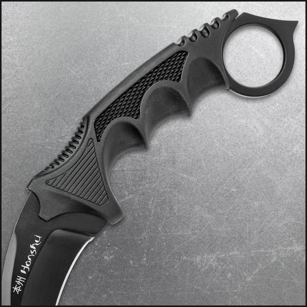 A hand is shown holding the karambit and using its curved black 7Cr13 stainless steel blade to cut a rope. image number 1