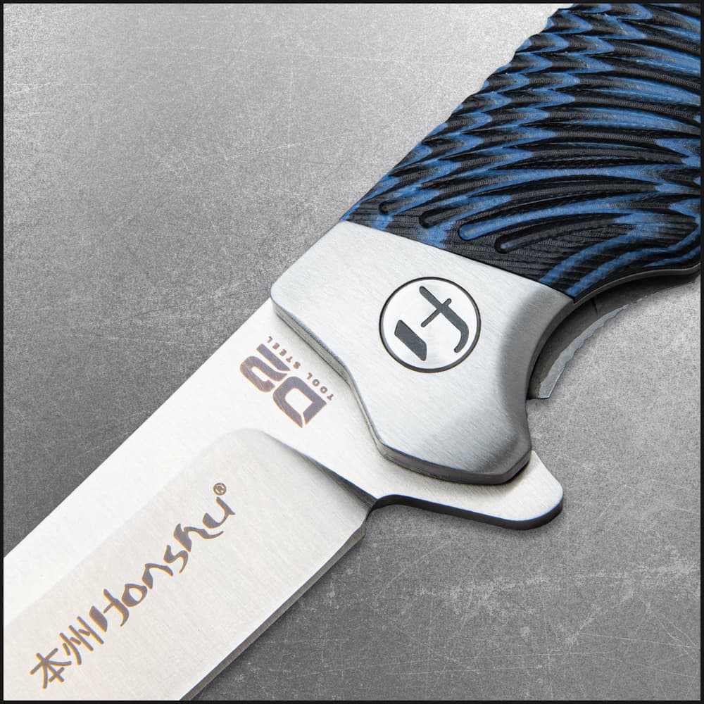 Closed Pocket knife with shining silver accents and a blue and black tie-dye style handle. image number 1