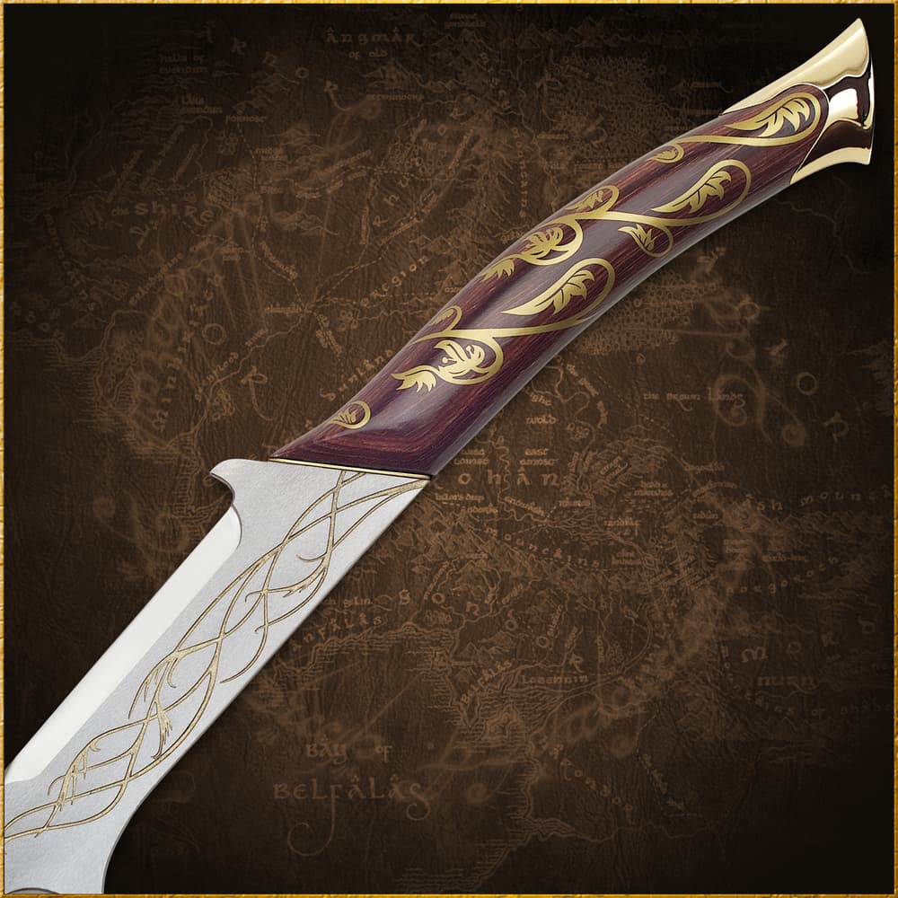 A closeup view of the wooden grip decorated with etched vines that also run the length of the blade. image number 1
