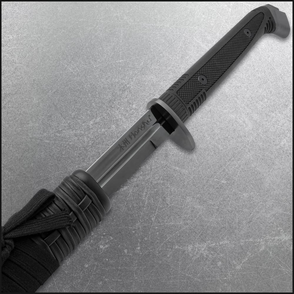 The double-edged sword slides smoothly into its black wooden sheath image number 1