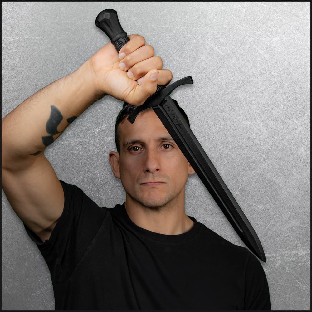 Full image of a person holding the Training Dagger. image number 3