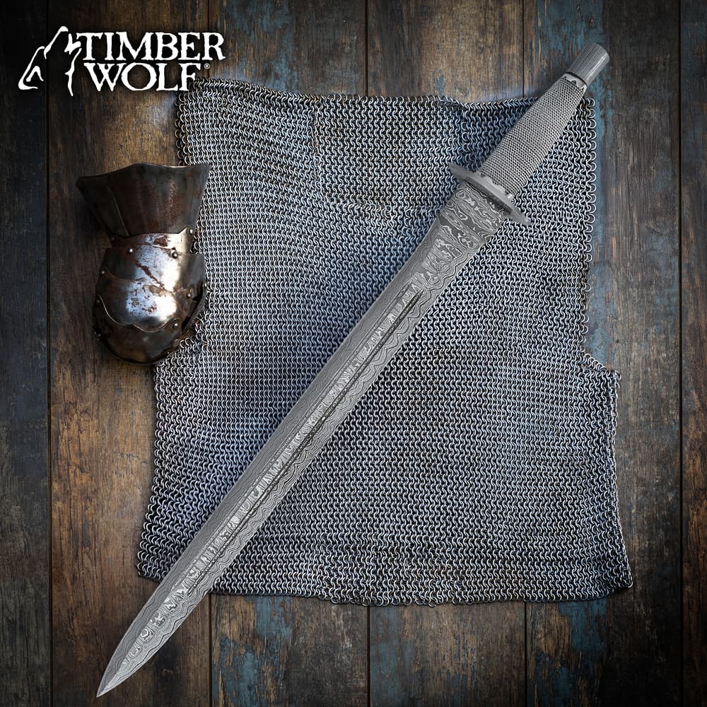 Sword on chainmail with gauntlet on wooden surface image number 0