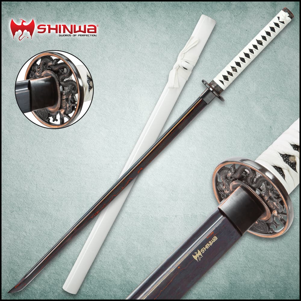 Shinwa White Knight katana closeup with view of ornate tsuba, white cord wrapped handle, and black Damascus steel blade. image number 0