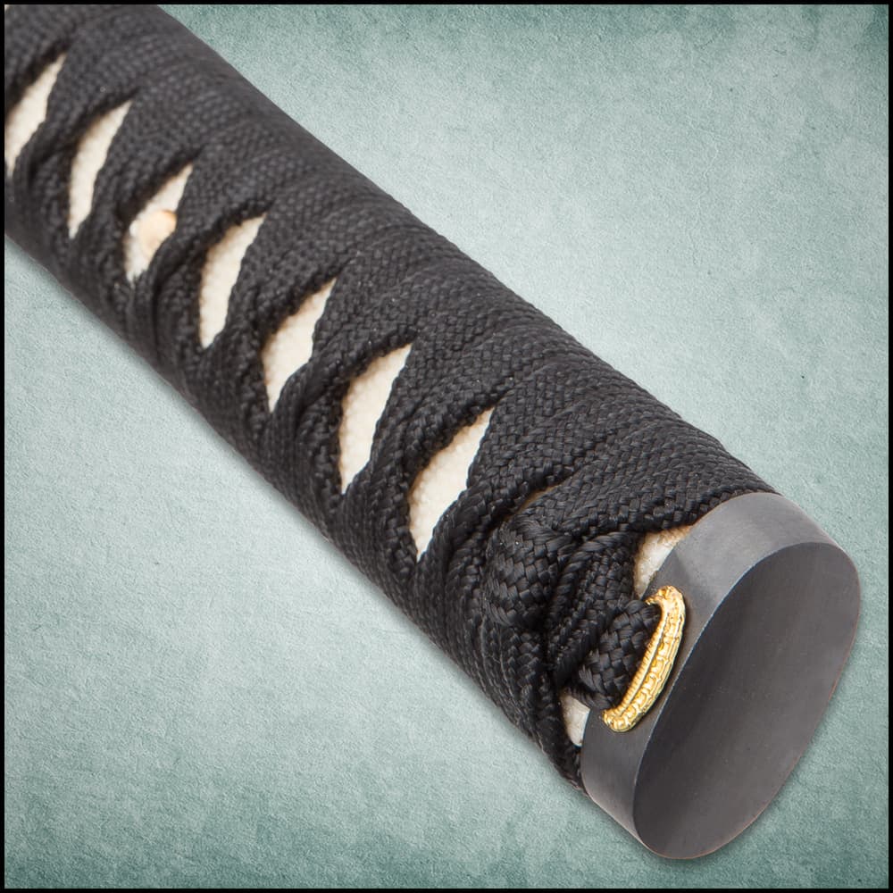 All three swords have a white ray skin handle with black cord wrapped around it and brass menuki and have a wooden display. image number 3