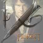 The Sting sword scabbard has metal fittings and leather belt strap, shown atop The Hobbit character Bilbo Baggins holding the Sting sword. 
