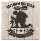 The artwork, etched in black on the lid, includes a silhouette of a solider kneeling above a banner that says, “Service. Valor. Sacrifice.”