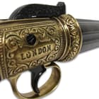 The replica features six, brass-finished metal revolving barrels, stamped “London”, and it has high-quality wooden grips