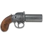The replica features six, grey-finished metal revolving barrels, stamped “London”, and it has high-quality wooden grips