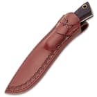 The 8 1/2” overall knife slides securely into its genuine leather belt sheath, which features decorative embossing
