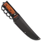 Trench knife enclosed in a black nylon sheath with an exposed pakkawood handle with a matte balck knuckle buster grip.
