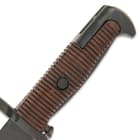 Our authentic reproduction has a 16” high carbon iron blade and muzzle ring guard with ridged wooden handle scales