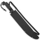 The machete is shown secured in its black nylon belt and shoulder sheath.