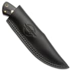 The knife can be stored in its included premium leather belt sheath, pressed with the HibbenKnives logo.