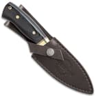 The knife can be secured into its included black leather belt sheath with snap closure handle strap.