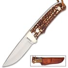 The Schrade Uncle Henry Pro Hunter Knife can be carried and stored in its leather belt sheath