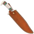 The 16” overall bowie knife slides smoothly into its premium leather belt sheath with snap strap closure