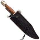 The 16” bowie knife can be carried and stored in its brown leather belt sheath, which has decorative, beaded tassels