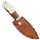 The 9” fixed blade knife can be secured into its premium brown leather belt sheath with snap strap closure.
