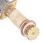 The intricately crafted handle is of genuine natural-colored bone accented with brass filework and red and brass spacers