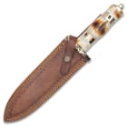The dagger comes with a leather belt sheath.
