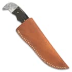 The 9” overall fixed blade knife slides securely into a premium leather belt sheath with a snap strap closure