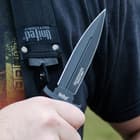 The 9 1/2” knife has a 5 1/4” AUS-8 stainless steel blade with non-reflective black coating, shown held by a person.