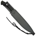 The all-black knife is shown secured into its reinforced genuine leather belt sheath with paracord lanyard.