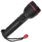 The flashlight has a checkered grip and a wrist lanyard.