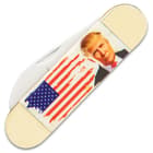 It has white bone handle scales with a 3D-printed American Flag and a portrait of President Trump on the front