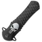 The knife has a textured black aluminum handle with a silver inlaid skull.