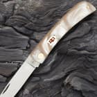 This knife’s imitation pearl handle features a classic white and red kissing crane shield logo.