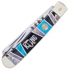 The handle is made of black and turquoise bone, accented with King-themed engraved artwork and stainless spacers