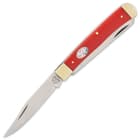The red G10 handle features the Kissing Crane American Flag shield and is accented by brass-plated pins and nickel silver bolsters