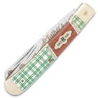 The handle scales are white bone with a green plaid etching and brown wood, complemented by nickel silver bolsters