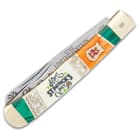 The handle scales are white bone engraved with “Happy St. Patrick’s Day” and green wooden panels, accented with brass spacers