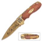 The lockback pocket knife has a 3 1/2” stainless steel drop point blade with a matte gold finish and decorative artwork
