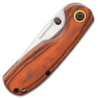 The pocket knife has pakkawood handle scales.