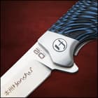 Closed Pocket knife with shining silver accents and a blue and black tie-dye style handle.
