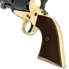 The wooden handle of the black powder revolver