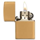 Zippo classic brushed brass lighter open with a flame
