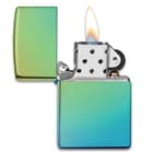 Zippo high polish teal lighter open with a flame