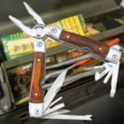 This multitool has several useful stainless steel tools that flip out of the hardwood grips.