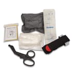 The kit includes a combat tourniquet, 4” emergency pressure bandage, 8 1/5”x 6 1/5” emergency blanket, a pair of trauma shears, compress gauze and a skin marker