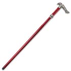 Sword cane with faux leather wrapping encased in a red shaft with hidden button leading to metal hilt and fittings
