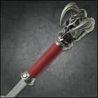 Zoomed view of the horned skull of Evruc pommel and red waxed cord-wrapped handle. 