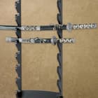 Two Samurai swords of differing sizes sit within the black wooden eight sword wall display with room for six more swords. 