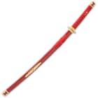 The 39” overall sword slides into a glossy red wooden scabbard with a shiny gold accent featuring a faux red jewel